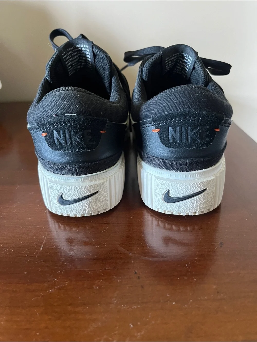 Nike Women’s Black Sneakers with White Swoosh and Red Tongue Logo